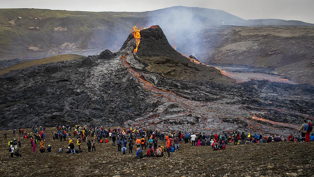 Watch as active volcano provides stunning spectacle for hikers and tourists in Iceland