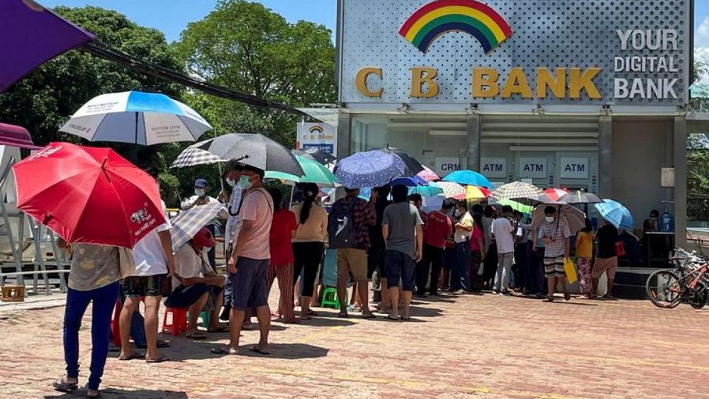 Lines, tokens and money brokers: Myanmar's crumbling economy runs low on cash