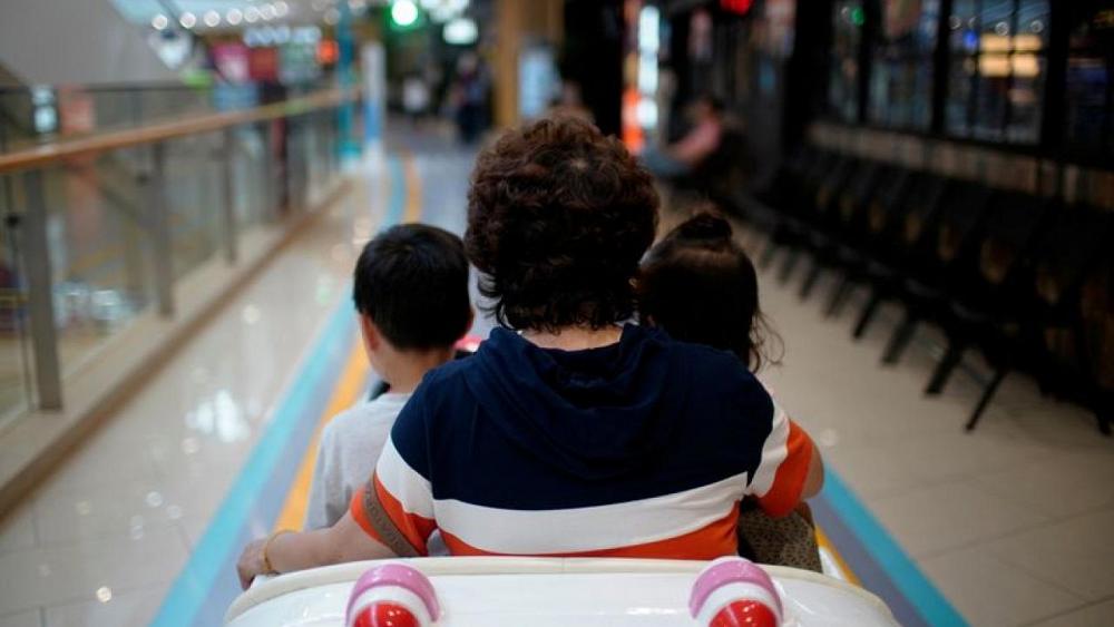 China's new three-child policy draws scepticism, cost questions