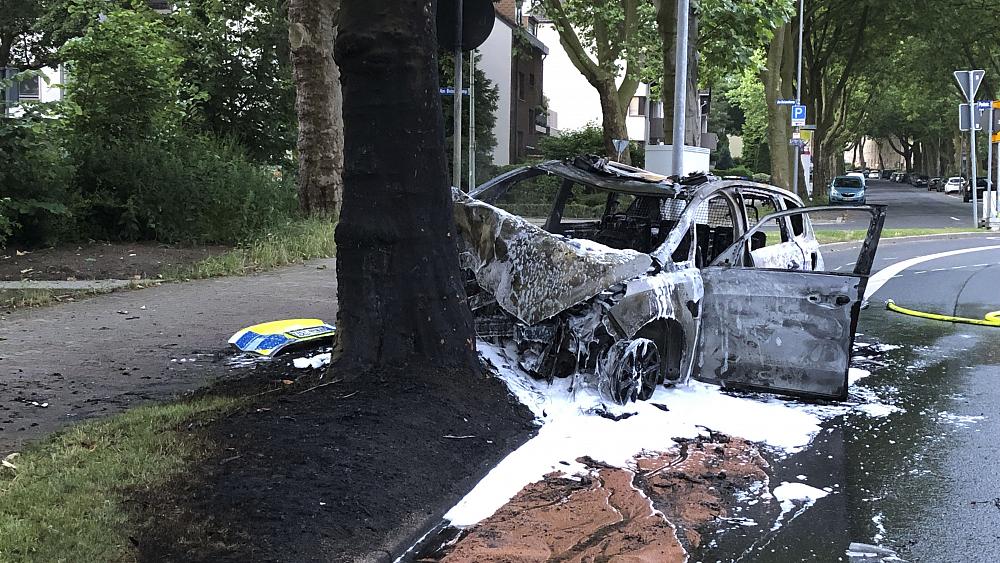 German police officers saved from burning car by passing students